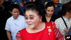  FILE - Former Philippines first lady, Congresswoman Imelda Marcos arrives at the Commission on Elections to support her daughter, Gov. Imee Marcos in filing for the May 2019 midterm elections in Manila, Philippines.