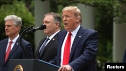 U.S. President Donald Trump makes an announcement about U.S. trade relations with China and Hong Kong as National Security Advisor Robert O'Brien, Secretary of State Mike Pompeo and Treasury Secretary Steven Mnuchin listen in the Rose Garden of the White 
