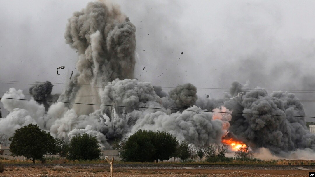 Thick smoke, debris and fire rise following an airstrike by the U.S.-led coalition in Kobani, Syria, as seen from Mursitpinar, on the outskirts of Suruc, at the Turkey-Syria border, Oct. 12, 2014. 