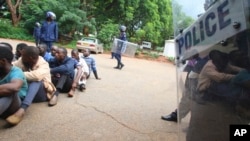 A policeman stands guard as some of the people arrested during demonstrations over the hike in fuel prices, make their court appearance at the magistrates courts in Harare, Jan,16, 2019. 