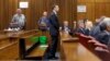 Olympic and Paralympic track star Oscar Pistorius stands in the dock at the North Gauteng High Court in Pretoria, September 11, 2014. Pistorius, the double amputee who became one of the biggest names in world athletics, faced justice on Thursday as a Sout