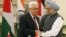 Indian Prime Minister Manmohan Singh, right, shakes hands with Palestinian President Mahmoud Abbas after the leaders signed agreements in New Delhi, India, Tuesday, Sept. 11, 2012.