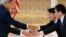 U.S. Secretary of State John Kerry, left, U.S. Defense Secretary Chuck Hagel, second from left, Japanese Defense Minister Itsunori Onodera second from right, and Japanese Foreign Minister Fumio Kishida, shake hands before the Japan-US 2+2 meeting in Tokyo, Oct. 3, 2013.