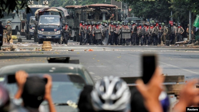 FILE PHOTO: Police stand on a road during an anti-coup protest in Mandalay, Myanmar, March 3, 2021.