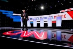 A CNN employee stands on the stage, Jan. 14, 2020, before a Democratic presidential primary debate hosted by CNN and the Des Moines Register in Des Moines, Iowa.