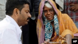 A doctor cleans the wound of a woman farmer at the end of her six-day march on foot, in Mumbai, India, March 12, 2018.