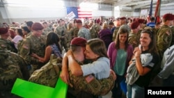 FILE - John Jacoby, a paratrooper with the 1st Brigade Combat Team, 82nd Airborne Division, hugs his girlfriend Emiliee Chance after returning home from Afghanistan at Pope Army Airfield in Fort Bragg.