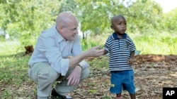 Chip Lyons with child in Kenya.