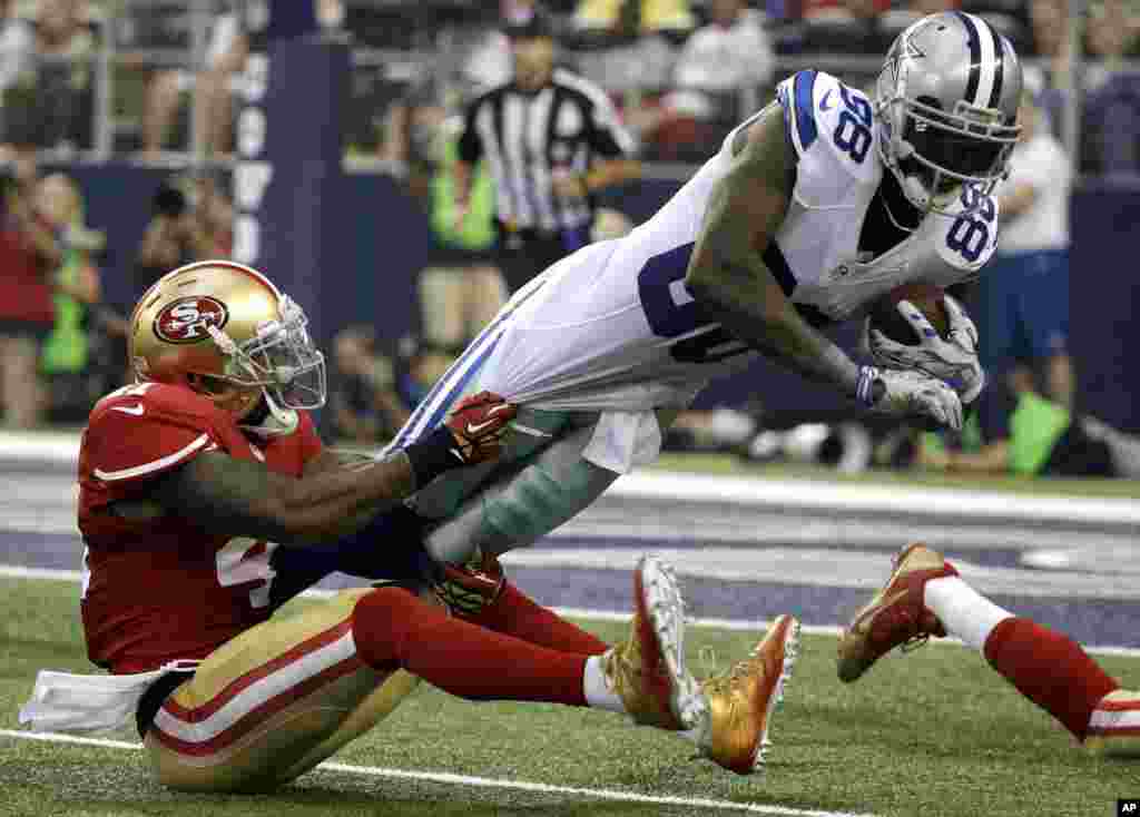 Dallas Cowboys tight end Gavin Escobar (89) is brought down by San Francisco 49ers strong safety Antoine Bethea (41) in the first half of an NFL football game, in Arlington, Texas, USA, Sept. 7, 2014.