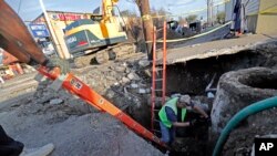 Workers fix a sewer main below the sidewalk in Mid City New Orleans, Jan. 31, 2018. City officials say New Orleans needs more than $11 billion to update key parts of its infrastructure.