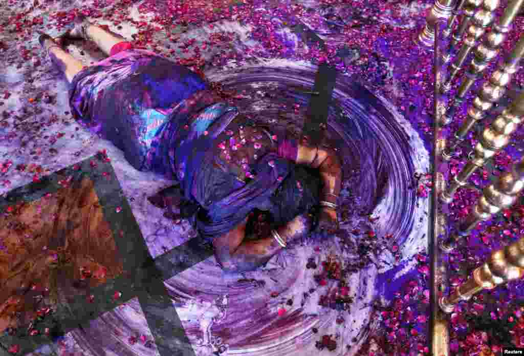 A Hindu woman prays while lying on the floor of a temple during Holi celebrations in western India. Holi, also known as the Festival of Colors, marks the beginning of spring and is celebrated all over India.
