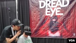 Para pengunjung mengantri untuk mendapatkan giliran mencoba permainan VR di stand pameran DreadEye. (Foto: VOA/Naratama)