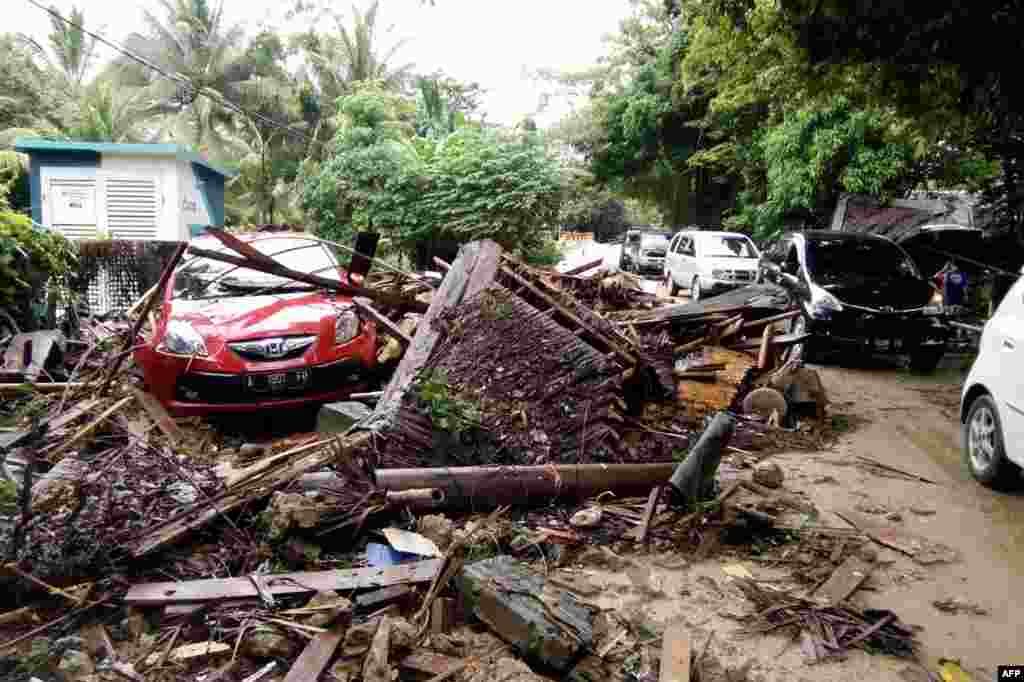 A damaged vehicle is seen amid wreckage from buildings along Carita beach, Dec. 23, 2018, after the area was hit by a tsunami Saturday following an eruption of the Anak Krakatoa volcano.