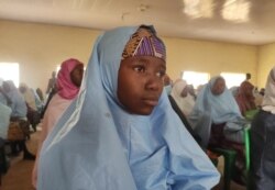 A kidnapped girl, reacts as she prepares to reunite with family members in Jangebe, Zamfara state, on March 3, 2021 after they were kidnapped from a boarding school in northwestern Nigeria, on Feb. 26, 2021.