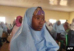 A kidnapped girl, reacts as she prepares to reunite with family members in Jangebe, Zamfara state, on March 3, 2021 after they were kidnapped from a boarding school in northwestern Nigeria, on Feb. 26, 2021.