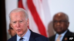 Democratic presidential candidate former Vice President Joe Biden, speaks as he is endorsed by House Majority Whip, Rep. Jim Clyburn, D-S.C., background, in North Charleston, S.C., Feb. 26, 2020. 