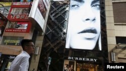 A model is seen on the screen of a Burberry store at Causeway Bay shopping district in Hong Kong, China, July 16, 2015