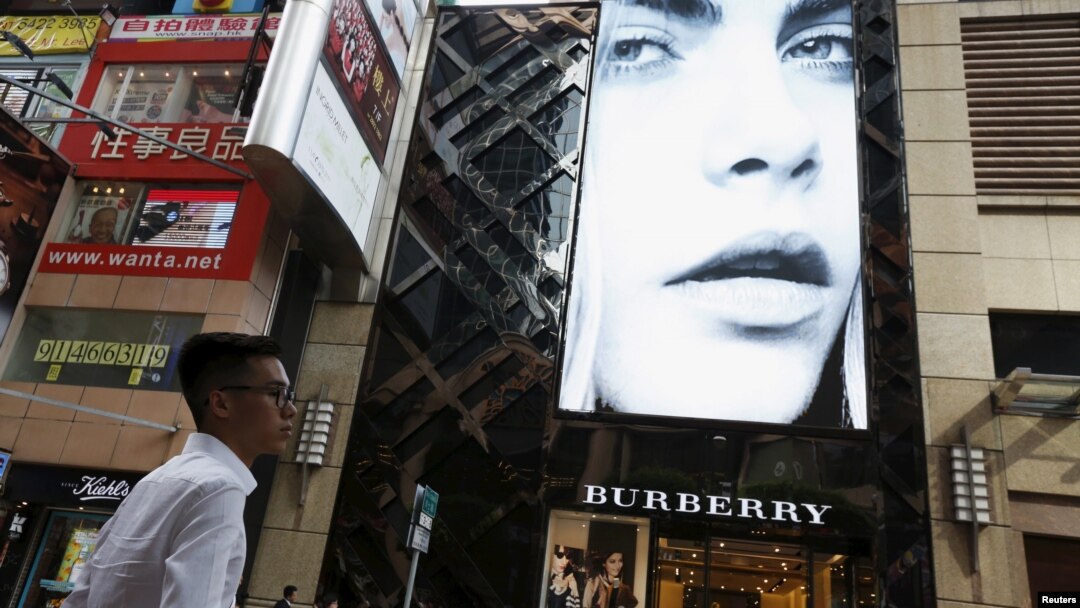 A model is seen on the screen of a Burberry store at Causeway Bay shopping district in Hong Kong, China, July 16, 2015
