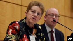 FILE - Dr. Ellen Wright Clayton, chair of the Committee on Diagnostic Criteria for Myalgic Encephalomyelitis/Chronic Fatigue Syndrome (l) during an open meeting at the Institute of Medicine in Washington, Feb. 10, 2015.