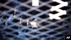 FILE - Migrants are seen inside a truck after their rescue by the Libyan Coast Guard off the coast of Tripoli, March. 3, 2017. Some arriving migrants have been sold into slavery, the International Organization for Migration reports.