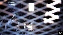 FILE - Migrants are seen inside a truck after their rescue by the Libyan Coast Guard off the coast of Tripoli, March. 3, 2017. Some arriving migrants have been sold into slavery, the International Organization for Migration reports.