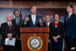 Sen. Mark Warner, D-Va., vice-chair of the Senate Intelligence Committee, is joined by fellow Democrats during a news conference at the Capitol in Washington, July 23, 2019.