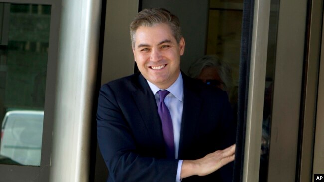 CNN's Jim Acosta walks out of the U.S. District Courthouse with a smile, Nov. 16, 2018, in Washington.