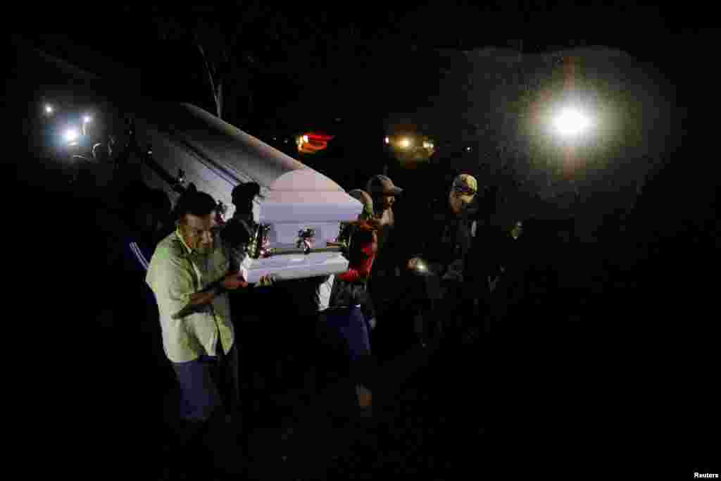 Friends and family members carry the coffin with remains of Jakelin Caal, a 7-year-old girl who handed herself in to U.S. border agents earlier this month and died after developing a high fever while in the custody of U.S. Customs and Border Protection, to her home village of San Antonio Secortez, in Raxruha, Guatemala.