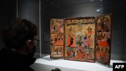FILE —A visitor looks at "Triptych with Crucifixion," while touring the "Africa & Byzantium" exhibit during a press preview at The Metropolitan Museum of Art in New York on November 16, 2023.