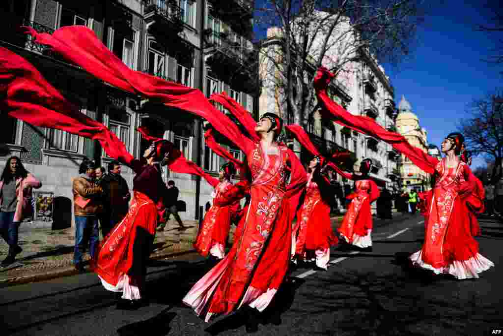 Revelers perform during celebrations for the Chinese New Year parade, marking the year of the Dog, in Lisbon, Portugal, Feb. 10, 2018.