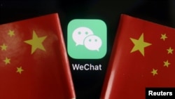 he messenger app WeChat is seen in between China flags in this illustration picture taken August 7, 2020. REUTERS/Florence Lo/Illustration/File Photo