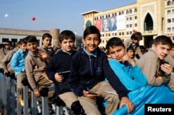 FILE - Students of Tevfik Ileri Imam Hatip School wait for the arrival of President Tayyip Erdogan for the opening ceremony in Ankara.