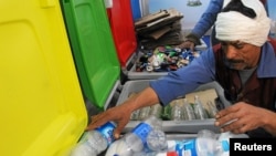 A worker sorts through recycling bins at a center that offers residents money in exchange of their recyclable garbage in an attempt to keep the streets clean in Cairo, Egypt, March 11, 2017. 