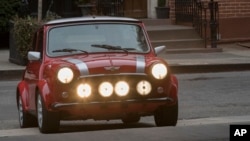 The classic Mini Electric arrives at during a press preview , Tuesday, March 27, 2018, in New York. (AP Photo/Mary Altaffer)