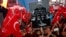 Supporters of Turkish President Recep Tayyip Erdogan wave their national flags and hold a portrait of Fethullah Gulen, a U.S.-based Muslim cleric, with Turkish words that read: "the Coup nation traitor, FETO" (Feto is the nickname of Fethullah Gulen), du
