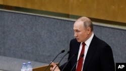 Russian President Vladimir Putin speaks a session prior to voting for constitutional amendments at the State Duma, the Lower House of the Russian Parliament in Moscow, Russia, Tuesday, March 10, 2020.
