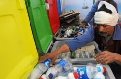 A worker sorts through recycling bins at a center that offers residents money in exchange of their recyclable garbage in an attempt to keep the streets clean in Cairo, Egypt, March 11, 2017.