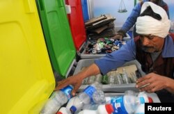 A worker sorts through recycling bins at a center that offers residents money in exchange of their recyclable garbage in an attempt to keep the streets clean in Cairo, Egypt, March 11, 2017.