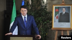 FILE - Italian Premier Matteo Renzi addresses the media during a joint press conference with his Algerian counterpart, Abdelmalek Sellal, in Algiers, Algeria, Dec. 2, 2014. 