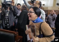 A supporter of ousted President Hisni Mubarak reacts in a courtroom to a verdict ordering a retrial in Cairo, Egypt, Jan. 13, 2015.