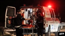 Medics at the scene of a car-ramming attack at the Ras Bidu checkpoint near the Israeli settlement of Givat Zeev, in the occupied West Bank, on January 7, 2024. Israeli police said that officers responding to the attack had shot and killed a Palestinian girl..