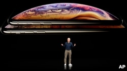 Apple CEO Tim Cook discusses the new iPhone XS and iPhone XS Max at the Steve Jobs Theater during an event to announce new products Wednesday, Sept. 12, 2018, in Cupertino, Calif. (AP Photo/Marcio Jose Sanchez)