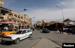 FILE - Vehicles drive past on a street in Mosul, 390 km (240 miles) north of Baghdad, March 12, 2012. Islamic State militants occupied the city in mid-2014.