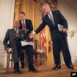President Clinton and Vice President Al Gore, back, help Herman Shaw, 94, a Tuskegee Syphilis Study victim, during a news conference May 16, 1997, when Clinton apologized to black men whose syphilis went untreated by government doctors.