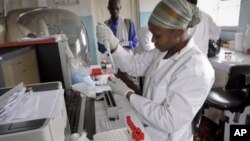 Lab technician Mercy Oluya tests blood samples for HIV at a clinic run by Medicins Sans Frontieres (Doctors without Borders) in the Kibera slum of Nairobi, Kenya.