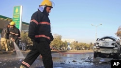 Afghan firefighters clear the site of a blast that killed a provincial judge in Jalalabad, capital of Nangarhar province, Afghanistan Wednesday, Jan. 7, 2015.