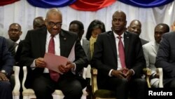 Haiti's Prime Minister Jack Guy Lafontant (L) checks documents beside President Jovenel Moise during Lafontant's inauguration ceremony at the National Palace in Port-au-Prince, Haiti, March 21, 2017. REUTERS/Andres Martinez 
