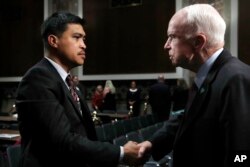 Senate Armed Services Committee Chairman John McCain, R-Ariz., right, shakes hands with Victor Sibayan, of Chula Vista, Calif., whose son, Navy Fire Controlman 2nd Class Carlos Sibayan, 23, died in the USS Fitzgerald collision, after a hearing on recent Navy incidents, Sept. 19, 2017, on Capitol Hill in Washington.