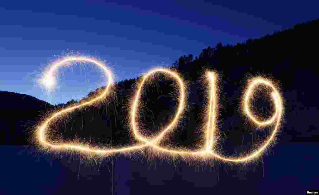 The numbers &quot;2019&quot; are written in the air with a sparkler near a tourist camp outside Krasnoyarsk, Russia, Dec. 31, 2018.