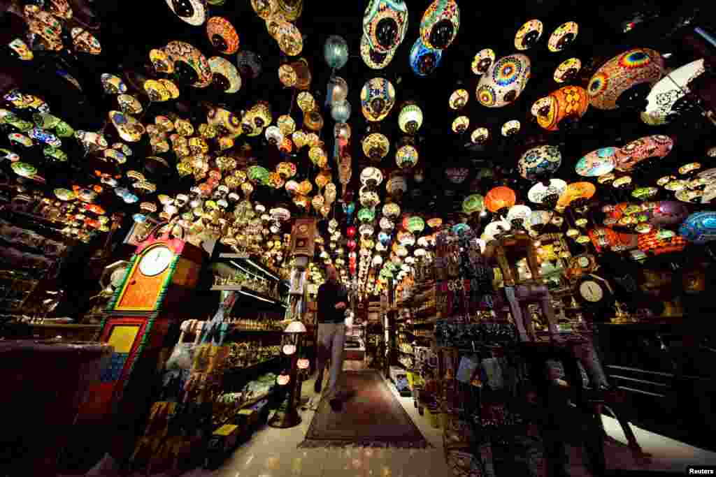 A visitor walks in a traditional Arabic design lights shop in down town Manama, Bahrain.